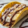 Delicious cheesecake cookie dough tacos filled with creamy cheesecake and cookie dough.