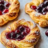 Freshly baked Cherry Cheese Danish with cherry filling and creamy cheese topping.