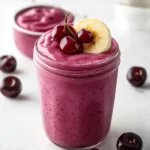 A refreshing Cherry Smoothie with fresh cherries and yogurt in a glass