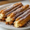 Delicious cookie dough cheesecake-stuffed churros on a plate