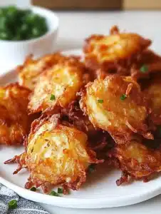Crispy Amish Onion Fritters Delight 7 Crispy Amish onion fritters served on a plate, perfect for snacking.