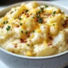Crockpot cheesy potatoes served in a bowl with melted cheese on top