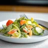 Fresh cucumber salad with herbs and dressing in a bowl