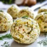 Dill Pickle Cheese Ball served with crackers on a platter