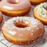 Freshly made glazed donuts with a shiny sugar coating