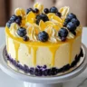 Slice of Lemon Blueberry Cheesecake Cake with blueberries on top