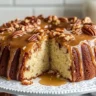 Pecan caramel cinnamon roll cream cheese pound cake on a white plate