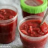 Jar of homemade Rhubarb Freezer Jam showcasing its vibrant color and texture.