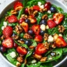 Fresh Spinach Strawberry Salad with Balsamic Dressing garnished with nuts