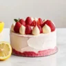 Sliced Strawberry Lemon Cake decorated with strawberries and lemon zest