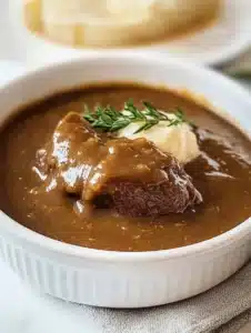 Delicious brown gravy without drippings served on a plate with mashed potatoes