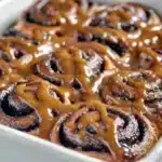 Freshly baked Chocolate Cinnamon Rolls topped with rich chocolate glaze