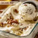 Bowl of homemade butter pecan ice cream with pecans on top