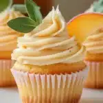 Delicious Honey Peach Cream Cheese Cupcakes with creamy frosting and fresh peaches