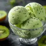 A vibrant bowl of homemade Kiwi Sorbet topped with kiwi slices.