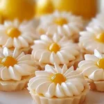 Delicious lemon tartlets served with fresh lemon slices on top.