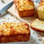 Freshly baked Pineapple Coconut Loaf topped with coconut flakes and pineapple slices