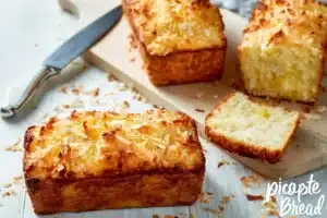 Freshly baked Pineapple Coconut Loaf topped with coconut flakes and pineapple slices