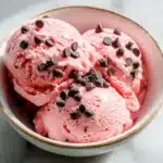 Delicious strawberry cheesecake ice cream in a waffle cone