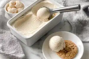 A bowl of creamy vanilla vegan ice cream topped with fresh fruit.