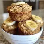 Freshly baked Banana Oatmeal Muffins on a rustic wooden table.