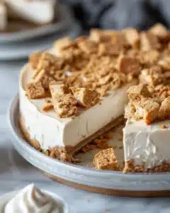 Sliced Cinnamon Toast Crunch Cheesecake with cereal topping on a plate