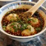 Homemade dumpling dipping sauce served with freshly steamed dumplings.