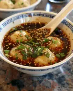 Homemade dumpling dipping sauce served with freshly steamed dumplings.