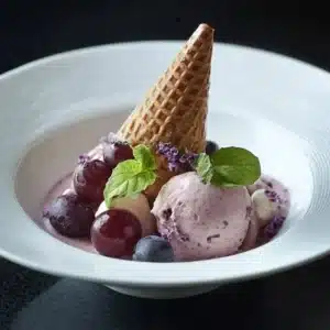 Grape Ice Cream 5 Delicious grape ice cream in a bowl with fresh grapes around it