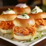Assorted sliders on a platter, ready to serve for a party or gathering.