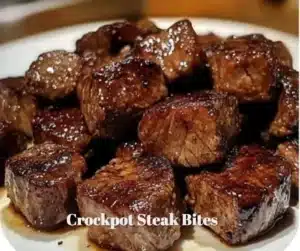Crockpot steak bites simmering in a rich sauce