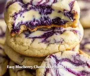 Easy Blueberry Cheesecake Swirl Cookies 4 Blueberry cheesecake swirl cookies on a white plate