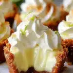 No-bake mini key lime pies topped with whipped cream and lime slices