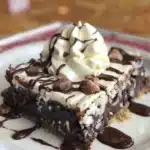 Decadent Hershey's syrup brownies, rich chocolate dessert served on a plate.