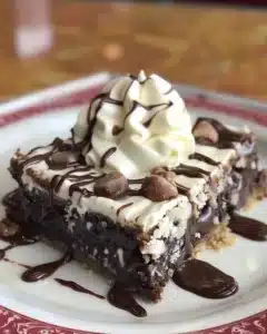Decadent Hershey's syrup brownies, rich chocolate dessert served on a plate.