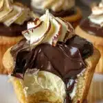 Delicious Boston Cream Pie cupcakes topped with chocolate and custard filling.