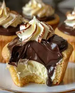 Delicious Boston Cream Pie cupcakes topped with chocolate and custard filling.