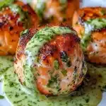 Plate of salmon balls served with creamy avocado sauce for dipping.