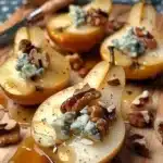 Walnut blue cheese honey pears elegantly arranged on a plate