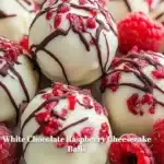 Delicious white chocolate raspberry cheesecake balls on a decorative plate.