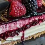 Delicious Blackberry Raspberry Cheesecake topped with fresh berries