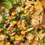 Bowl of viral creamy chicken poblano soup garnished with cilantro and lime.