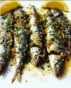 Mediterranean Garlic and Herb Crusted Roasted Sardines 7 Mediterranean garlic and herb crusted roasted sardines on a plate