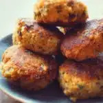 Plate of delicious mini fish cakes served with dipping sauce