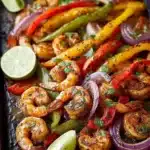 Sheet pan shrimp fajitas with vibrant vegetables and spices.