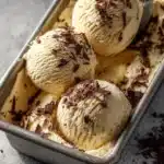 Delicious homemade tiramisu ice cream served in a bowl with chocolate shavings