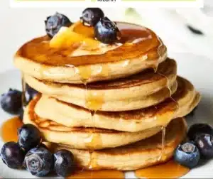 Fluffy 3-ingredient cottage cheese pancakes served with syrup and fruits