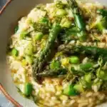 Creamy asparagus risotto served in a white bowl for a spring weeknight meal.