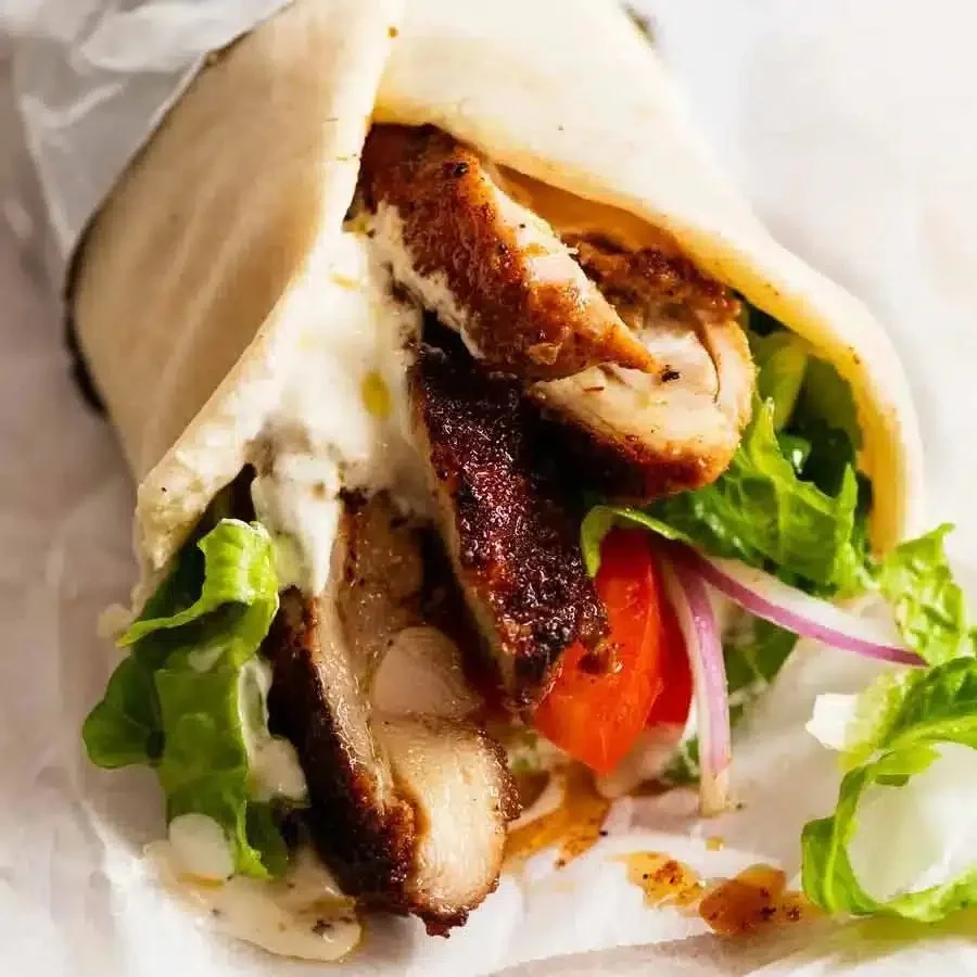 Homemade Chicken Shawarma served with pita and vegetables