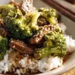 Delicious plate of Chinese beef and broccoli stir-fry with vibrant vegetables.